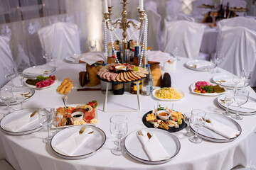 Elegant dining setup with a variety of dishes and decorations for gatherings and celebrations