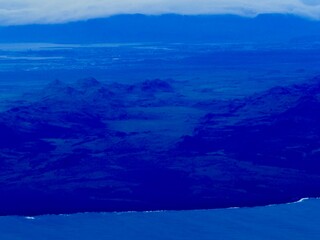 Aerial View Near Keflavík Airport in Iceland Showing Coastal Towns, Lava Fields, and Mountain Landscapes From an Airplane Window