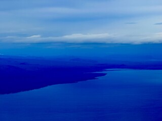 Aerial View Near Keflavík Airport in Iceland Showing Coastal Towns, Lava Fields, and Mountain Landscapes From an Airplane Window