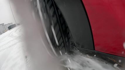 Car wheel sliding on snowy surface demonstrating ABS braking technique