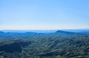 Extensive Green Mountain Range with Light Blue Sky Landscape