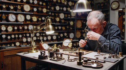 Senior watchmaker concentrating on repairing intricate clock mechanisms. Using a magnifying glass and specialized tools. Surrounded by a large collection of vintage timepieces in a detailed workspace