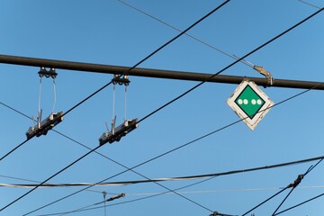 Traffic sign for trolley bus where it should stop. White and green rombus and four white dots