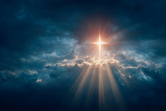 Radiant golden light beams break through dramatic dark clouds, creating a bright cross-shaped glow in the moody sky during dusk or dawn atmosphere