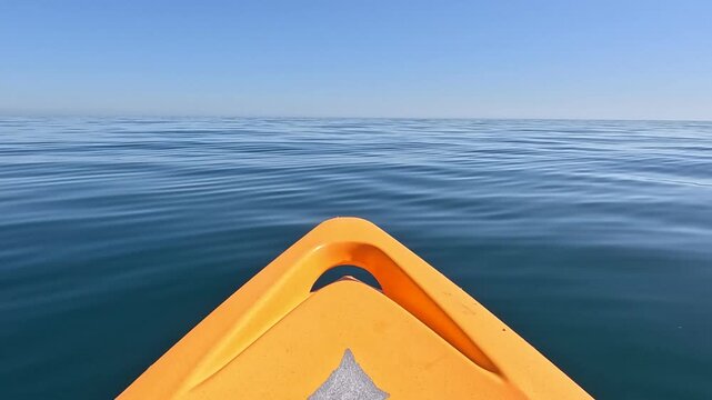 Kayak, ocean, serene orange kayak floating on calm blue water under clear sky