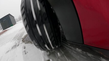 Car wheel sliding on snow with ABS braking in winter conditions