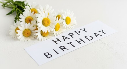 Birthday flowers with daisies and card saying Happy Birthday