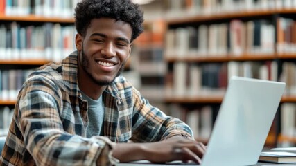 A young man working on his laptop in a library setting. He appears focused and determined, suggesting the importance of the task at hand.
