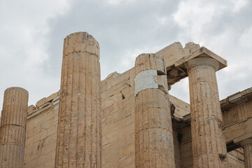 A detailed close-up of the Doric columns and marble architecture of the Acropolis in Athens, showcasing the ancient stonework and classical craftsmanship of this iconic Greek landmark.