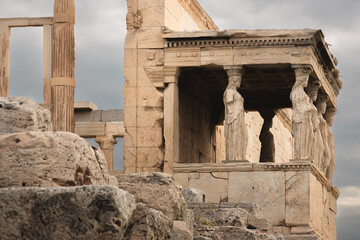 The ancient Erechtheion on the Acropolis in Athens, Greece, features the iconic Caryatid porch, classical columns, and historic statues, embodying the rich history and architecture of a significant ar