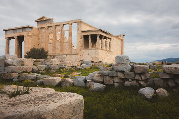 The ancient Erechtheion on the Acropolis in Athens, Greece, features the iconic Caryatid porch, classical columns, and historic statues, embodying the rich history and architecture of a significant ar