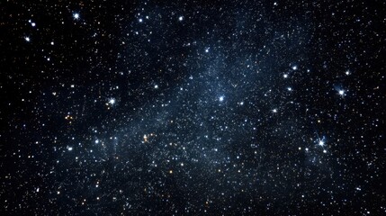 Obraz premium Small bright stars are visible in the dark night sky. The scene shows a vast space filled with countless twinkling lights. It is calm and clear with no clouds.