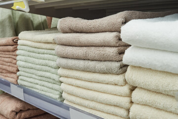 Towels in a stack on the shelves in the supermarket.