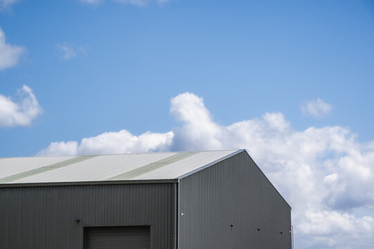 Low angle view of steel shed against blue sky, Victoria, Australia