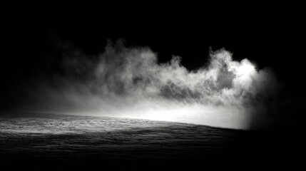 Fototapeta premium Fog covers a low dark surface while light shines through the mist in a dimly lit area. The scene captures the early morning atmosphere with a sense of mystery.