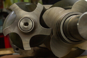 Disassembled industrial compressor or pump housing, revealing two large, precision ball bearings lubricated with oil and mounted in metallic bearing seats for rotor support