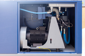 modern industrial screw air compressor cabinet, showcasing the electric motor, cooling system, and high-pressure tubing within the blue sound-dampening enclosure for professional use