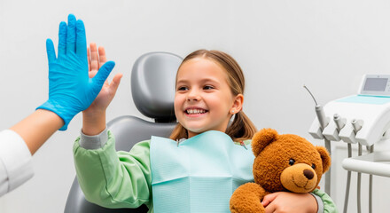 Happy child high-fiving dentist after dental checkup in a modern clinic