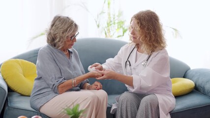 Experienced female healthcare professional providing personalized medical guidance, explaining medication dosage to senior patient during home consultation, demonstrating compassionate patient care