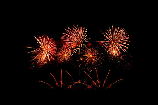 Many flashing colorful fireworks in event amazing with black background celebrate New Year, holiday and festival in night.