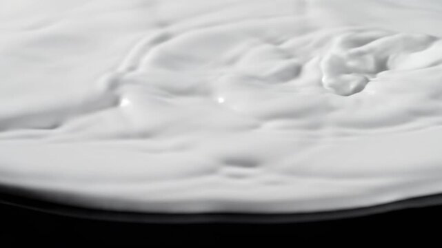 Hypnotic seamless loop of pristine white liquid flowing and rippling across an infinitely reflective blank surface void, digital, motion graphics