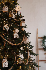 Christmas tree decorated lantern garland with wooden toys. Christmas interior