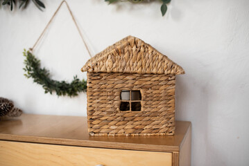 House container for toys made of natural materials on a cabinet in the room
