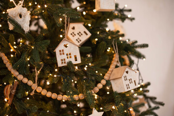 Christmas tree decorated lantern garland with wooden toys. Christmas interior