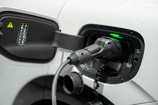 Charging an electric car, close-up. 