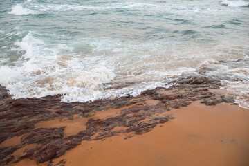 Beautiful beach water foam, beach landscape. Serene sea atmosphere of waves.