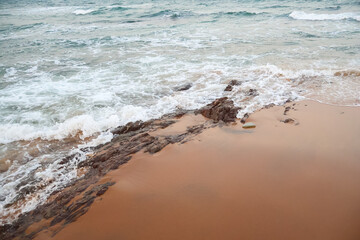Beautiful beach water foam, beach landscape. Serene sea atmosphere of waves.
