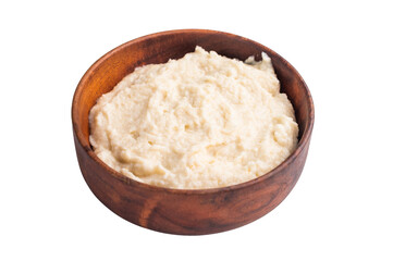 Creamy homemade horseradish sauce served in a rustic wooden bowl on a clean white background. Classic studio top view.