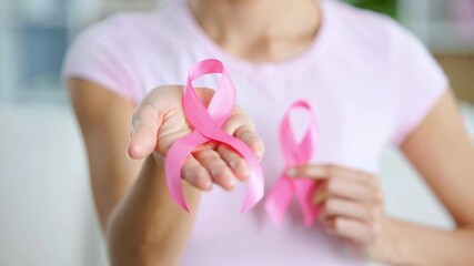Pink ribbon awareness symbol for breast cancer support, woman holding ribbon in hand, prevention, solidarity, October month campaign, hope, strength, care, medical help, health, female empowerment