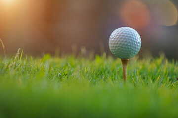 Golf ball on tee ready to play in a beautiful golf course.