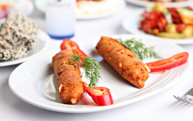 Mediterranean and Turkish meyhane cuisine with seafood, mezes, salads, grilled dishes, fresh fish, appetizers and desserts served in a modern restaurant setting.