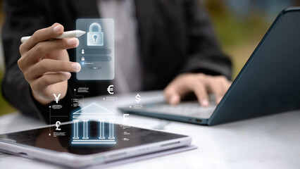 Business person using tablet with virtual banking and currency icons. Fintech concept.