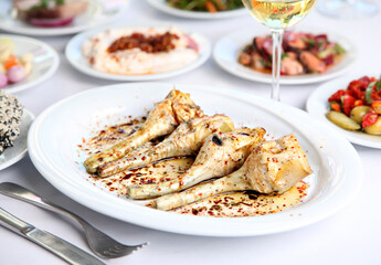 Mediterranean and Turkish meyhane cuisine with seafood, mezes, salads, grilled dishes, fresh fish, appetizers and desserts served in a modern restaurant setting.