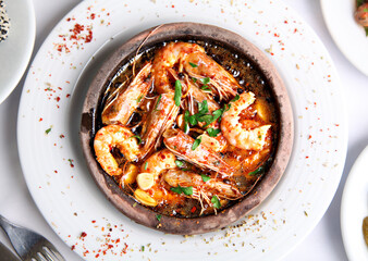 Mediterranean and Turkish meyhane cuisine with seafood, mezes, salads, grilled dishes, fresh fish, appetizers and desserts served in a modern restaurant setting.