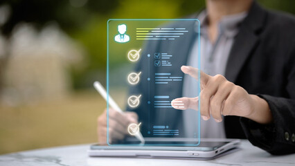 Business person using digital checklist interface for human resources and evaluation.