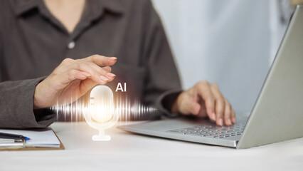 Business person typing on laptop with virtual AI microphone and sound wave icon.