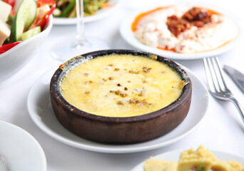 Mediterranean and Turkish meyhane cuisine with seafood, mezes, salads, grilled dishes, fresh fish, appetizers and desserts served in a modern restaurant setting.