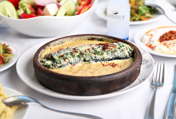 Mediterranean and Turkish meyhane cuisine with seafood, mezes, salads, grilled dishes, fresh fish, appetizers and desserts served in a modern restaurant setting.