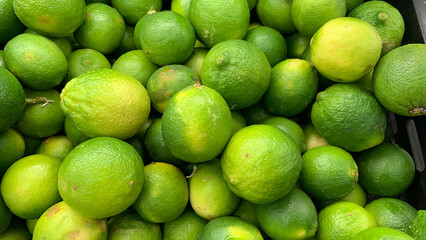 Top view of limes display in a wet market.