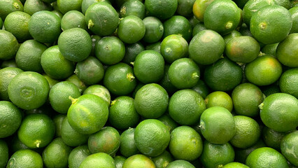 Top view of small limes display in a wet market with customizable space for text.
