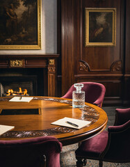 Obraz premium Exclusive meeting room with round table, ready for negotiation. Warm light, classic style. Perfect for finance, leadership, strategy, or design concepts.