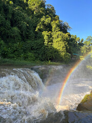 An aerial perspective of vibrant green hillside forests stretching toward mist-covered mountains, forming a peaceful and calming landscape in Bandarban, Chittagong Division, Bangladesh.