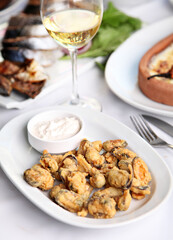 Mediterranean and Turkish meyhane cuisine with seafood, mezes, salads, grilled dishes, fresh fish, appetizers and desserts served in a modern restaurant setting.