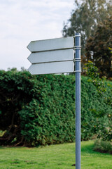 lank Directional Signpost with Three Arrows in a Park Setting