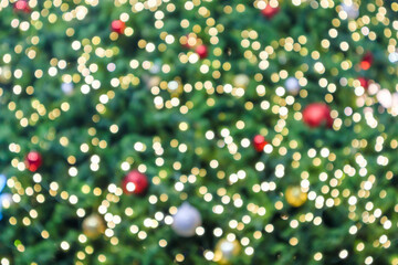 Fototapeta premium Abstract Christmas holiday with festive gold bokeh light on Christmas tree blurred background