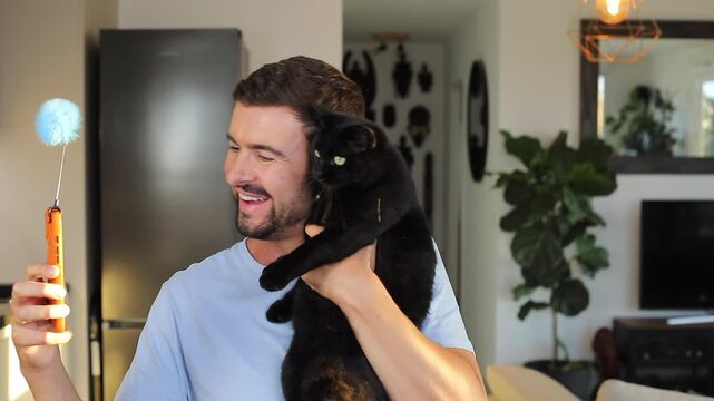 Man taking a video selfie with his black cat